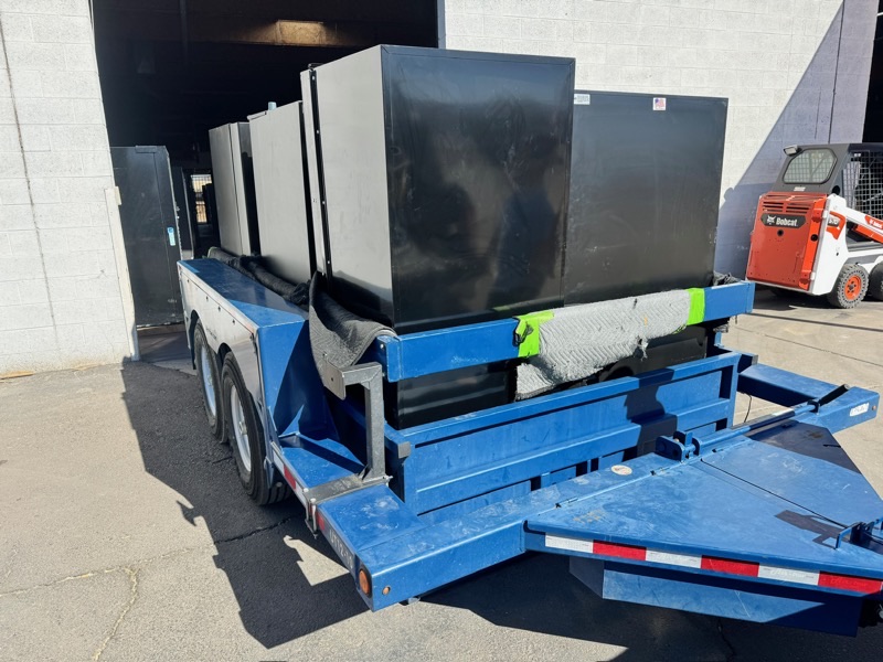 Heavy-duty trailer loaded with multiple gun safes for transport