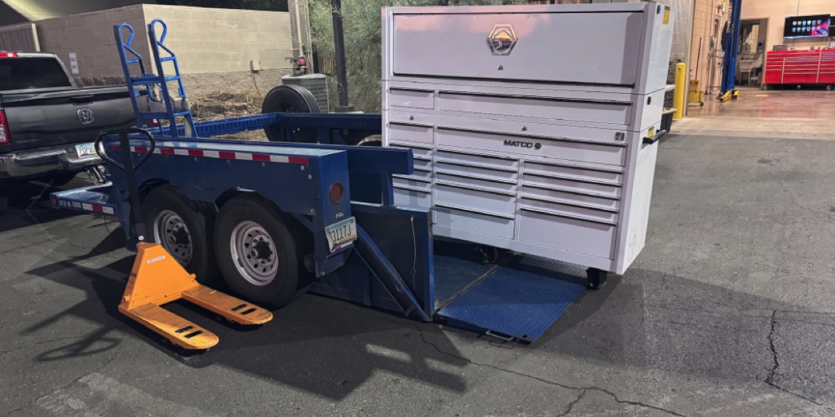 White Matco toolbox being loaded onto Air-Tow trailer at night